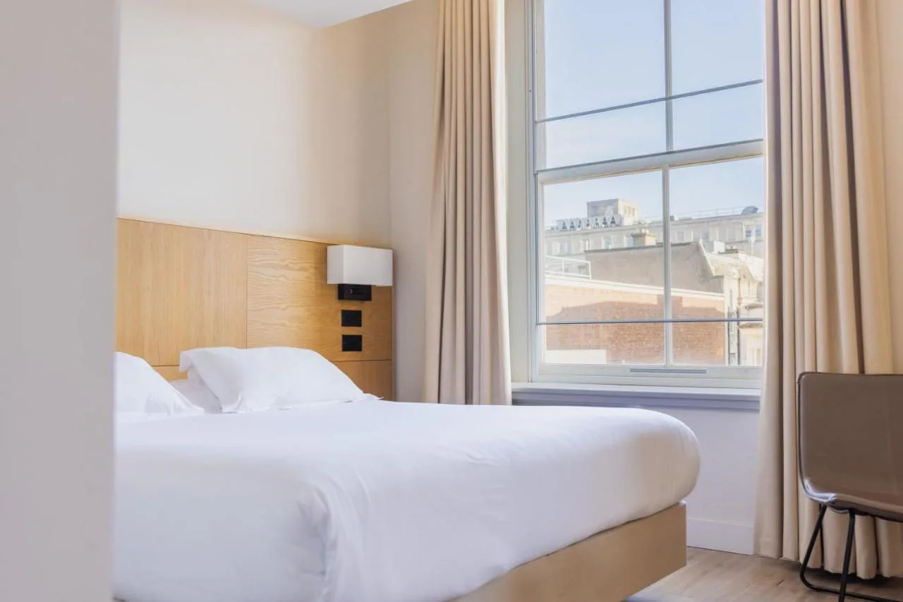 a hotel room with a bed and a large window at School Lane Hotel in Liverpool ONE in Liverpool